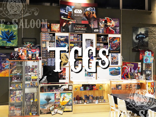 Display of trading card games with 'TCGS' branding in a store setting.
